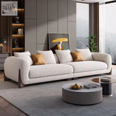 Modern off-white mariko sofa with plush sophistication featuring deep cushioning and rounded arms on dark wood legs