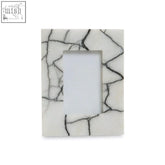 A small photo frame made of white marble with a black crackle pattern perfect for small photo displays