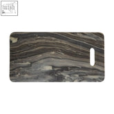 Gray and black marble patterned rectangular black marble chopping and serving board with white oval cutout tag