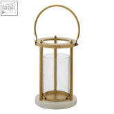 Gold-toned martina hurricane lamp with clear glass panels and a white marble base for stylish indoor lighting