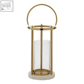 Gold-toned medium hurricane lamp with clear glass cylinder and circular handle for elegant indoor lighting