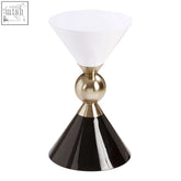A sleek martini gold side table lamp with a white shade and black rounded base connected by polished gold joint