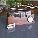 Wooden desk calendar and clock by maravi with brass flip blocks and round analog clock on a wooden desk calendar base