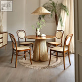 Round maya dining table in natural brown wood with rattan woven cane base and matching chairs for dining room