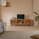 Light brown melia light oak media unit with sliding doors and vertical slats for stylish storage and display