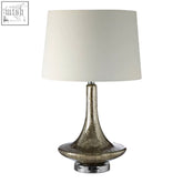 Silver mercury table lamp with a cream-colored drum shade perfect for adding vintage charm to any room