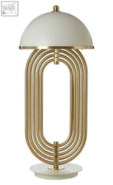 A metropolis table lamp with a sleek gold metal frame and a white dome shade perfect for modern decor