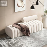 Cream-colored tufted mignon bread bench with cylindrical backrest and soft brown velvet fabric draped over it