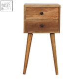 Light brown mango wood bedside table with two small drawers and black round knobs perfect for small spaces