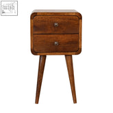 A mid-century modern mini chestnut curved bedside table made of solid mango wood with two drawers and tapered legs