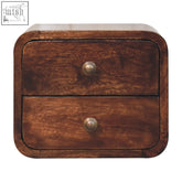 A dark brown california walnut mini curved wall mounted nightstand with two drawers and brass knobs
