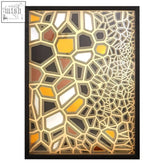 Modello gold and black paper sculpture wall art with interlocking yellow white black and brown triangles in sleek black frame
