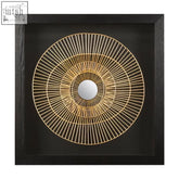 Modello gold and black wall art featuring a gold-toned circular metal design with concentric lines and black wall frame