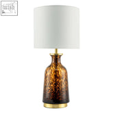 Modern amber and black snowflake speckle glass table lamp with a tortoiseshell base and white shade