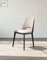 Modern contexture dining chair with beige upholstered seat and sleek black metal legs for stylish dining spaces