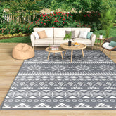 Gray and white geometric patterned mokani large outdoor rug made of waterproof plastic perfect for patio use