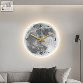A glowing moon earth luminous clock with a detailed gray lunar surface, gold hands, and illuminated edges