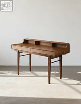 Mid-century modern moran carved office desk with warm brown finish, solid wood, tapered legs, and storage compartments