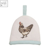 A cream linen oven mitt with a speckled chicken illustration and blue trim from the mrs henderson egg cosy line