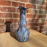 Murano tall glass vase in vibrant double-gourd shape with swirling blue and red patterns on a light base