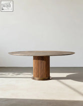 Round wooden dining table with fluted pedestal base and light brown top in murcell oval dining table style