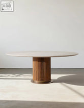 Murcell oval dining table with a sleek white marble top and fluted honey-toned wooden base oval dining table