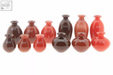 Set of ten glossy red and dark amber mouth blown glass budvases from dutz collection called nadiel red tints