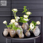 Nadiel taupe mix budvase set featuring sleek matte ceramic vases with white ranunculus and green ferns from dutz collection