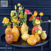 A dudt collection mouth blown glossy amber yellow orange ceramic budvase set in various sizes and shapes