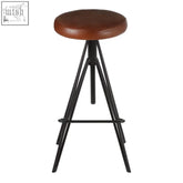 Brown leather stool with black iron tripod legs perfect for stylish seating and modern decor
