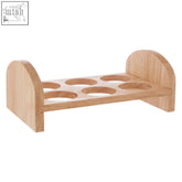 Light-colored rubberwood egg rack with six circular slots and curved ends for storing eggs securely
