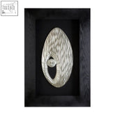 Nason framed oval carving silver wall art features a silver metallic oval design with textured patterns and black frame wall art