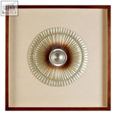 Nason framed silver round carving wall art features a circular metallic design with a silver disc and glass-like segments