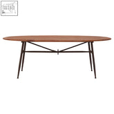 New foundry oval table with a warm wood top and black metal x-brace legs a sleek oval table design