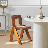 Brown leather rattan dining chair with woven cane back and seat and sleek rubber wood legs for dining use