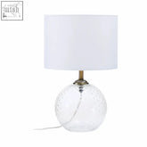 Noa clear glass table lamp with a textured spherical base and a white fabric shade for stylish lighting