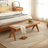 Wooden noah rattan bench with woven cane seat and angled legs in natural light brown finish