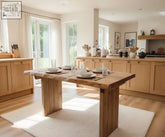 A rustic wooden dining table with a natural waney edge top and sturdy block legs perfect for edge dining
