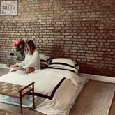 White duvet cover pillow cases and deep fitted sheet with black trim from nottinghill navy bundle set