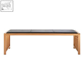 A sleek wooden bench with black leather cushion and rose gold finish for stylish seating and decor