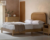 Light oak oakham double bed frame with curved rattan headboard and matching nightstand made from oak solids