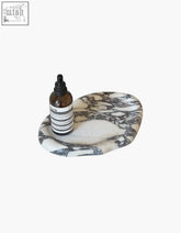 A sleek oval-shaped white marble tray with black veining perfect for home decor the octavia tray with offer financing