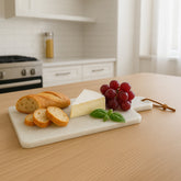 Off white marble rectangular paddle board with natural stone texture and tapered handle by kindia