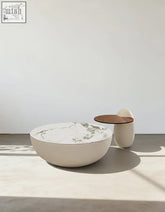 Cream-colored nesting coffee table with white marble top and rounded base from the oliver nesting coffee table white collection