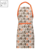 Beige orange leaf apron with peach and gray teardrop pattern and orange trim on neck loop and waistband