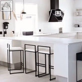 Modern black metal orion bar stool with white upholstered seat perfect for stylish kitchen or bar spaces