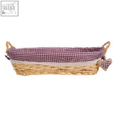 Woven wicker oblong bread basket with purple gingham lining lace trim and heart tag on handle