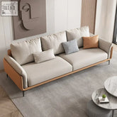 Oslon sofa with beige upholstered plush cushions wooden frame and orange leather accents minimalist design