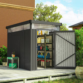 Gray galvanised steel garden shed with roof windows and open door showing shelves stocked with gardening tools