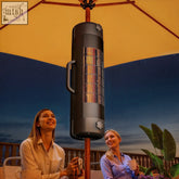 Black cylindrical outsunny electric patio heater with metal grille and handle mounted on umbrella pole with 2 heat settings